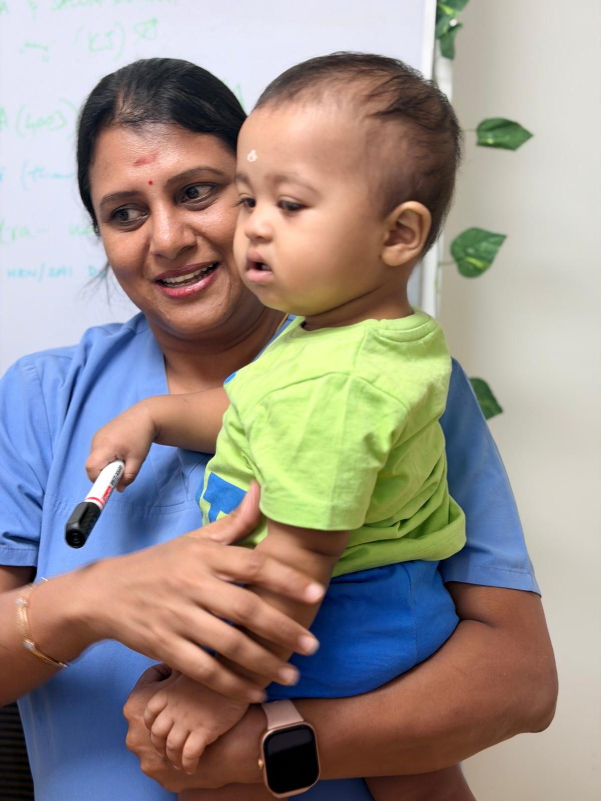 Dr. Sandhya caring for a young child in the clinic