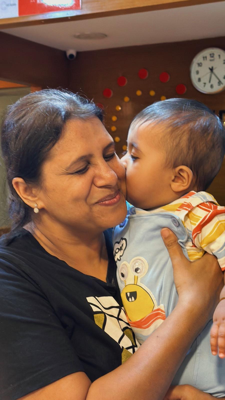 A warm moment between Dr. Sandhya and a child