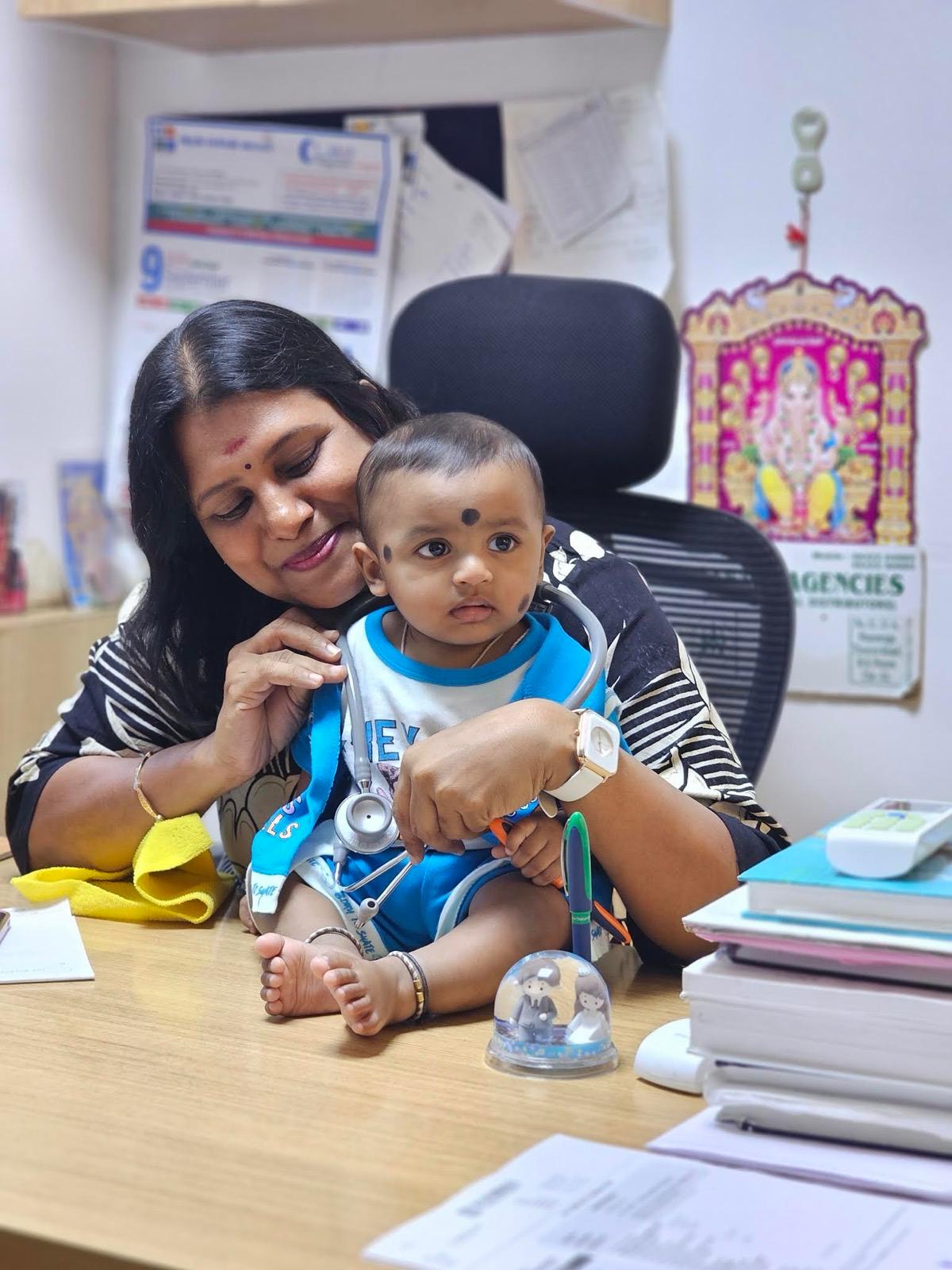 A child enjoying a friendly visit with Dr. Sandhya